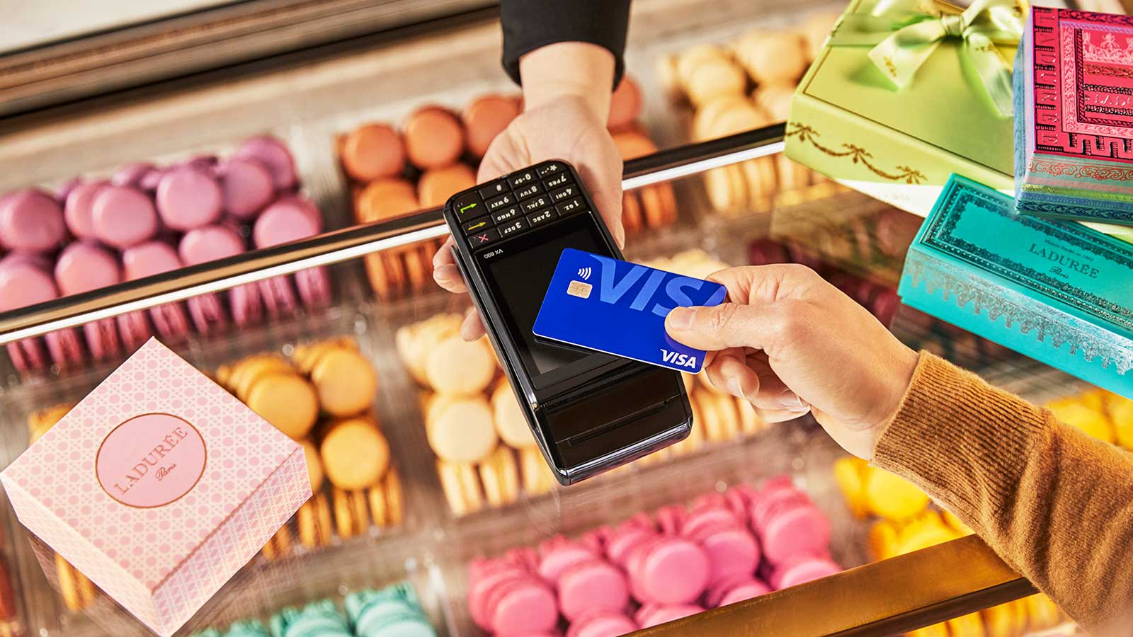 Picture of tap to pay contactless Visa card purchasing macarons